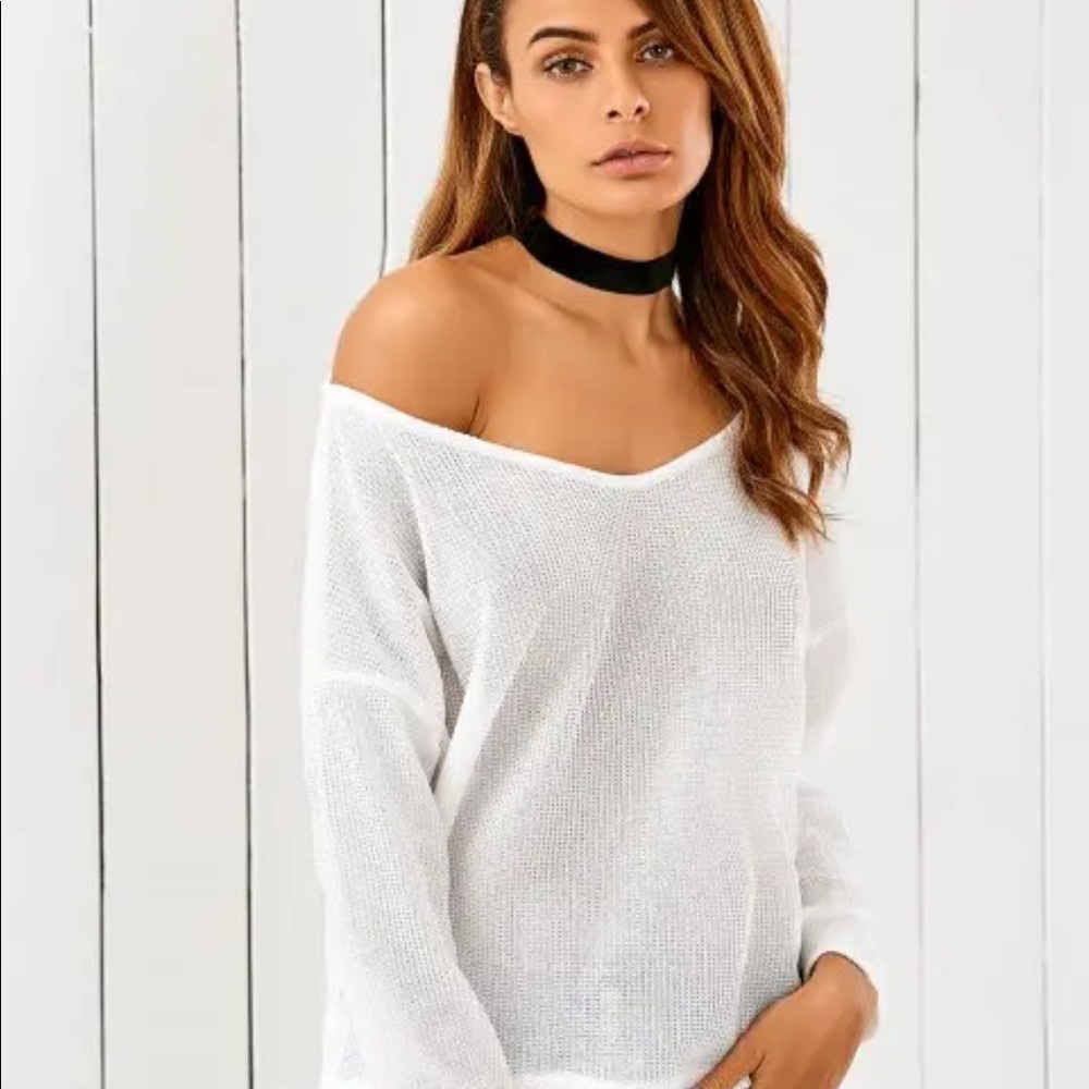 Loose, off-shoulder light white sweater